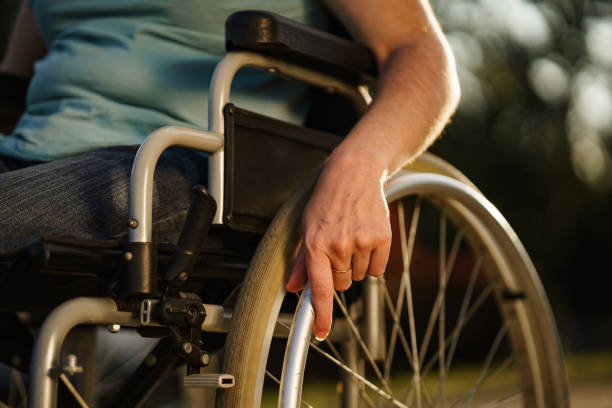 istock Close up women's hand pushing wheelchair 2205045570