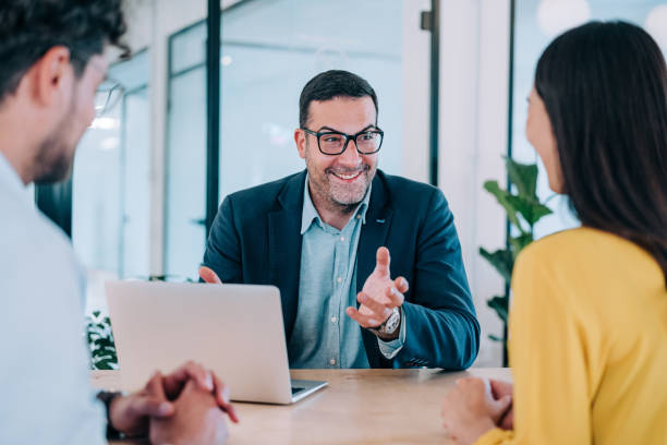 istock Group of business persons talking in the office. 2205045621
