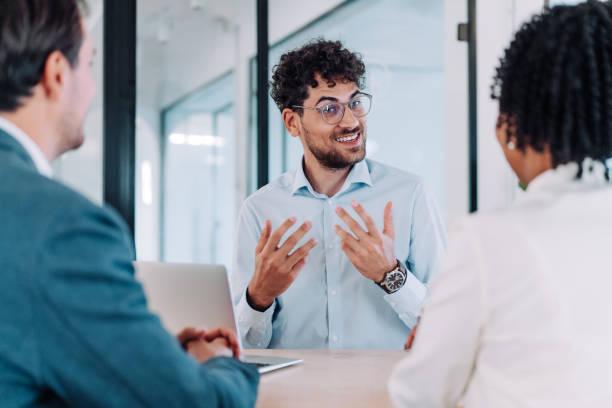 istock Group of business persons talking in the office. 2205045656