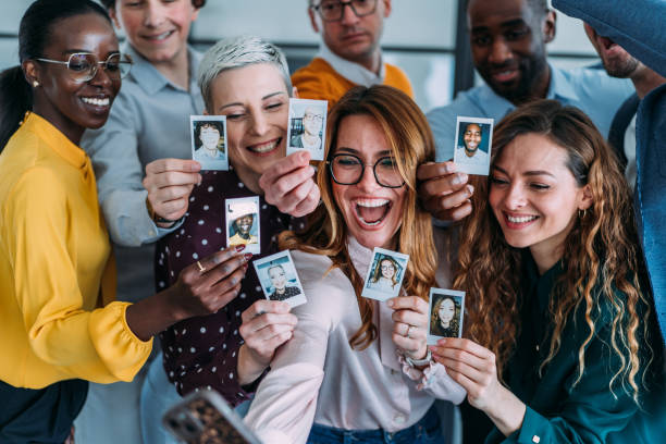 istock Happy colleagues making photos with instant camera. 2205046312