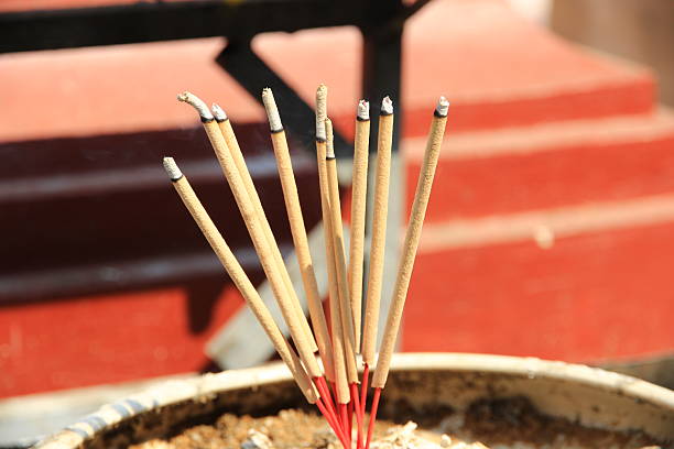 istock Many incense sticks burning with smoke in a pot. 2205046996