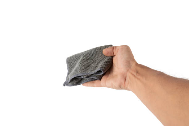 istock Male hand holding a cleaning cloth or dust rag isolated on white background 2205049355