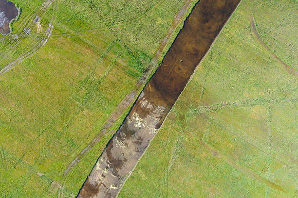 rectangular trench excavated in a field for the preparation of a construction site, aerial zenithal view with a drone