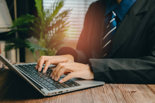 istock Business Professional Working on Laptop in Modern Office Environment with Natural Light, Business concept 2205053192