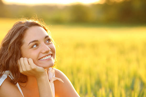 istock Happy woman dreaming in a wheat field 2205054233