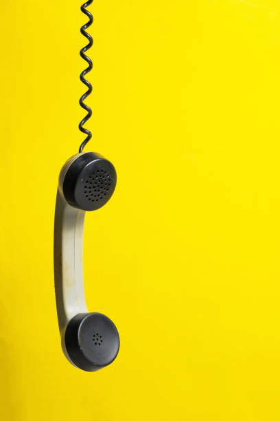 istock Retro telephone handset on yellow background with copy space for text. 2205055015