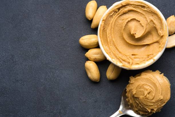 istock Delicious and healthy peanut butter on black background 2205062868