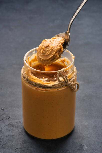 istock Delicious and healthy peanut butter on black background 2205062976