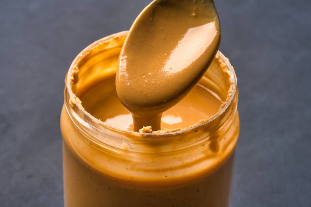 istock Delicious and healthy peanut butter on black background 2205063035