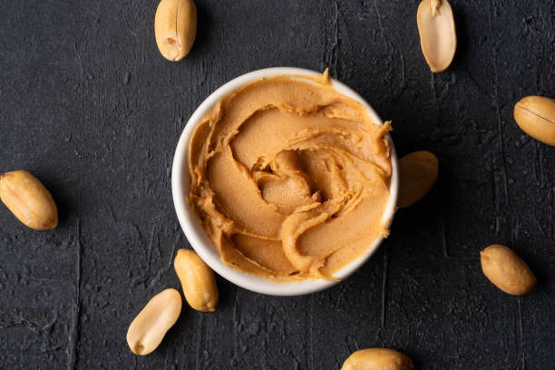 istock Delicious and healthy peanut butter on black background 2205063054