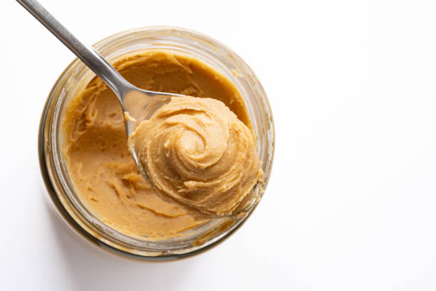 istock Delicious and healthy peanut butter on white background 2205063220