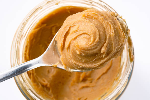 istock Delicious and healthy peanut butter on white background 2205063241