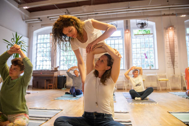 istock Group of people doing relaxation exercises with a yoga instructor 2205063274