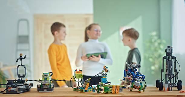 Children collaborate to build robots, enhancing creativity and enthusiasm in STEM education for a better future