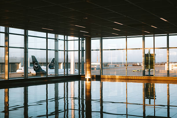 istock Empty international airport terminal with large windows. Natural evening window light, wide angle, no people 2205068837