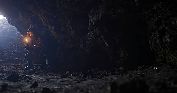 istock Embarking on an unforgettable exploration inside a mysterious cave while holding a torch 2205069481