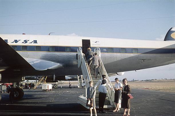 Catalonia, Spain, 1960. Passengers boarding a Lufthansa Lockheed Super Constellation aircraft. Also: flight crew.