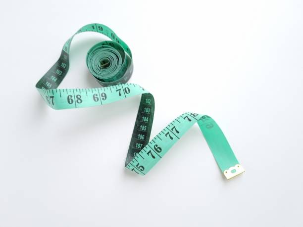 istock Green measuring tape. Close up 2205073484