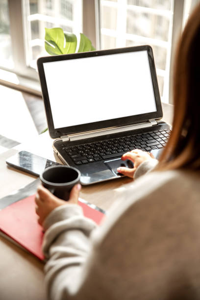 istock Girl working on laptop with cup of coffee 2205074468