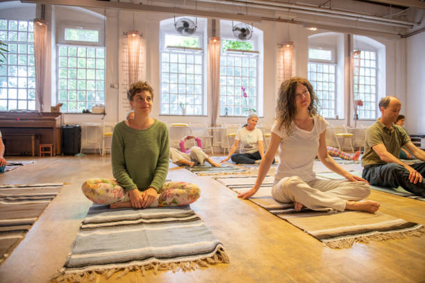 Group of people doing relaxation exercises, yoga and Feldenkrais method.