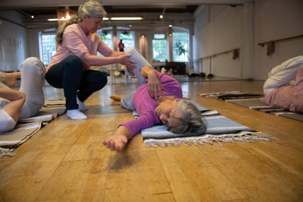istock Yoga instructor leading a class of relaxation exercises 2205075610