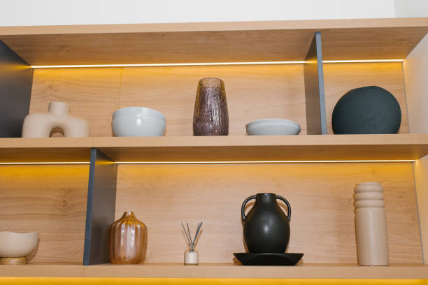 istock Stylish Decorative Items On Wooden Shelves 2205075888