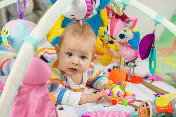 istock Baby playing on a toy mat. Child with an educational toy. Early development 2205078014