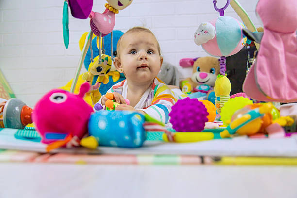 istock Baby playing on a toy mat. Child with an educational toy. Early development 2205078074