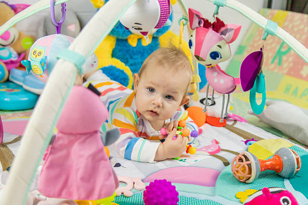 istock Baby playing on a toy mat. Child with an educational toy. Early development 2205078092