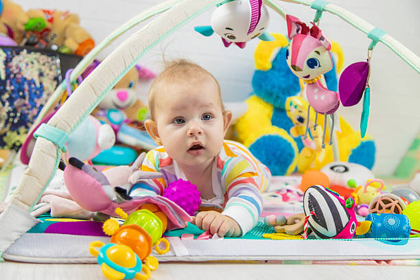 istock Baby playing on a toy mat. Child with an educational toy. Early development 2205078108
