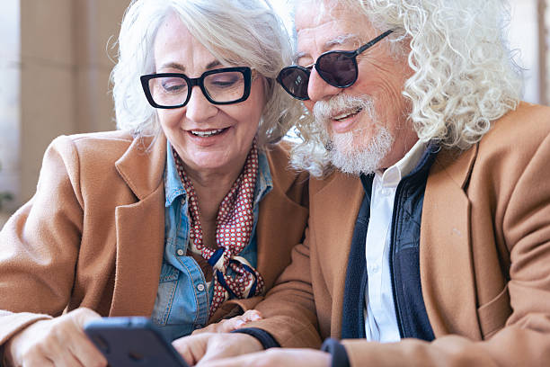 istock Happy senior couple using smartphone together, smiling and enjoying technology. 2205079171