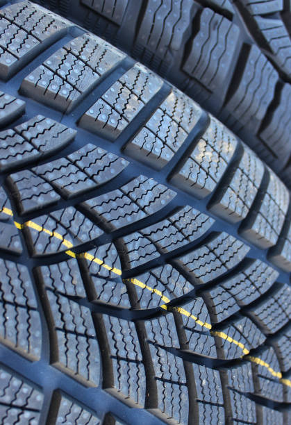 Modern winter tire tread closeup that has passed the braking test on ice and marked with a new pictogram of an icy mountain peak