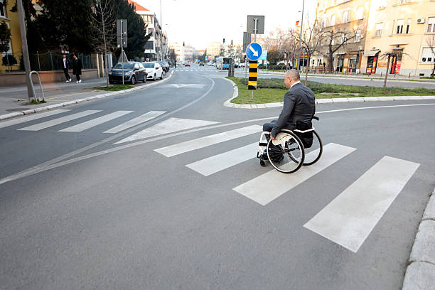istock Disabled businessman crossing a street 2205079592