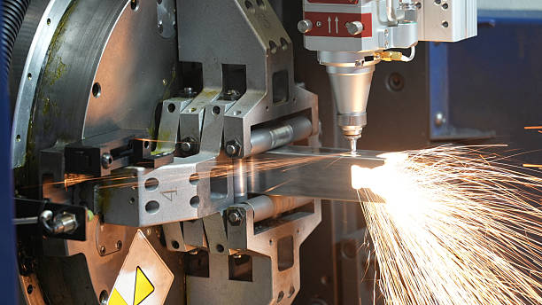 CNC machine tool laser cutting and engraving a stainless steel pipe