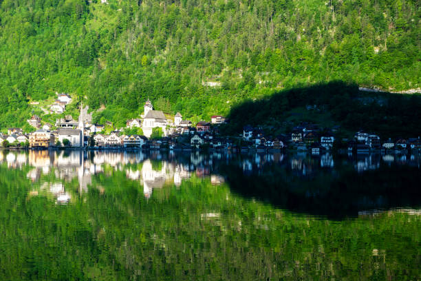 Hallstatt reflected in morning in the lake , Austria