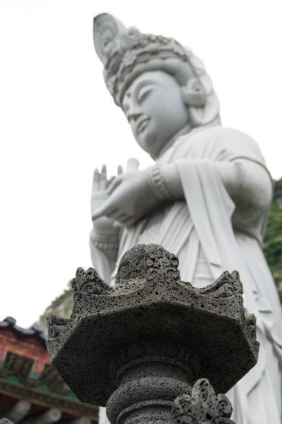 istock low-angle view of the stone tower and Buddha statue 2205084769
