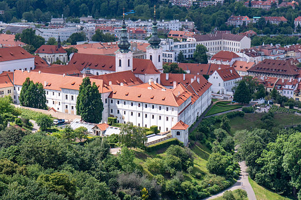 istock Panoramic view of Prague with the Vltava River, historic bridges, and red rooftops, surrounded by lush greenery. Stunning European cityscape showcasing Czech Republic’s architectural and natural beaut 2205087467