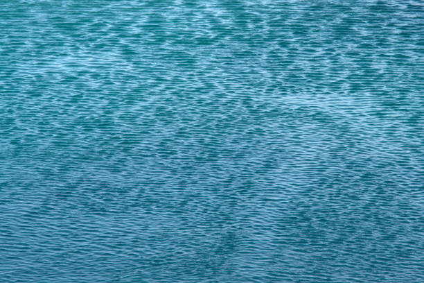 Small lake ripples and soft sunshine reflections. Useful for backgrounds.