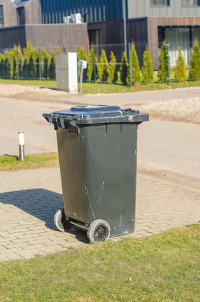 istock gray plastic garbage bin with wheels sits on a paved path in a residential area 2205089322