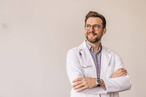 istock Confident doctor smiling and looking away with crossed arms 2205091173