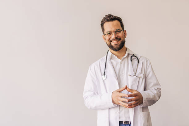istock Portrait of smiling doctor with folded hands and stethoscope 2205091521