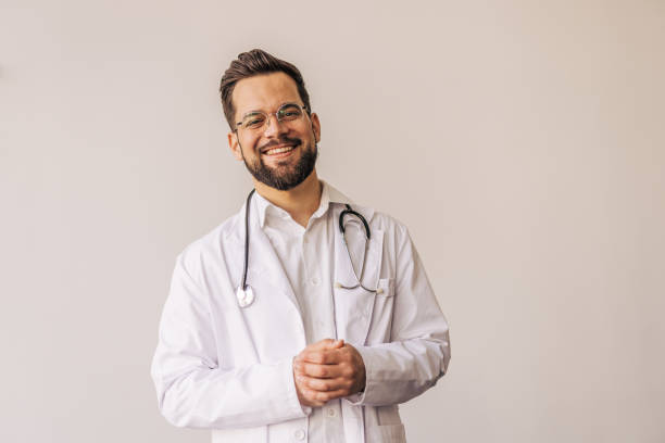 istock Young doctor smiling with stethoscope and lab coat 2205091537