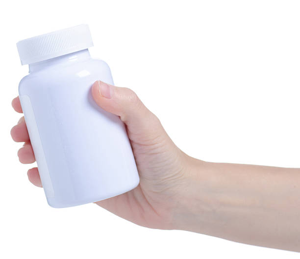 istock White jar with pills capsule medicine pharmacy in hand 2205091794