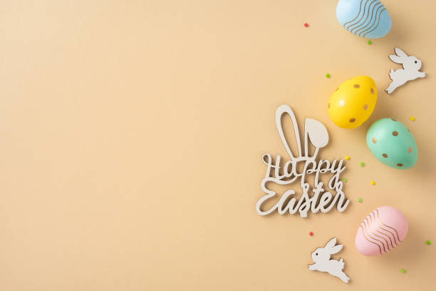 istock Cheerful Easter concept showcasing painted eggs and bunny decorations arranged on a neutral surface 2205091824