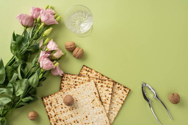 istock Flat lay composition of matzah, walnuts, a nutcracker, flowers, and a glass, symbolizing a relaxed Passover atmosphere 2205091852