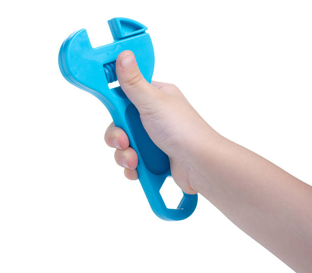 istock Children's toy adjustable wrench in hand 2205091942