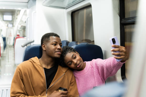 istock Young couple taking a selfie on the train while traveling 2205092584