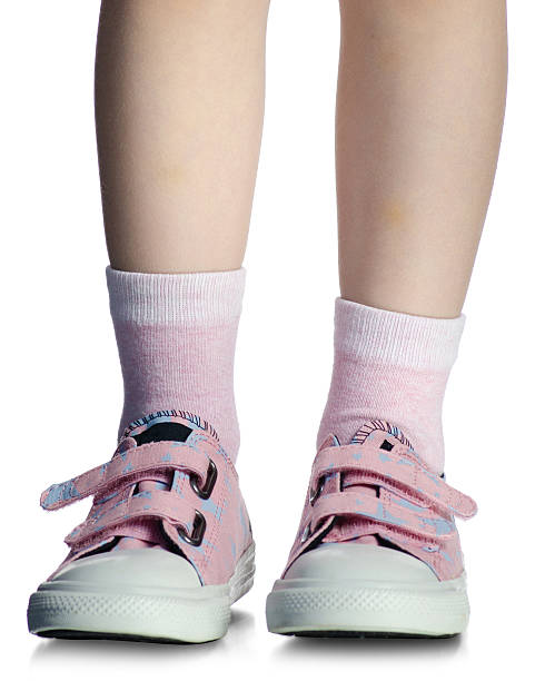 istock Kids legs on pink sneakers 2205094064