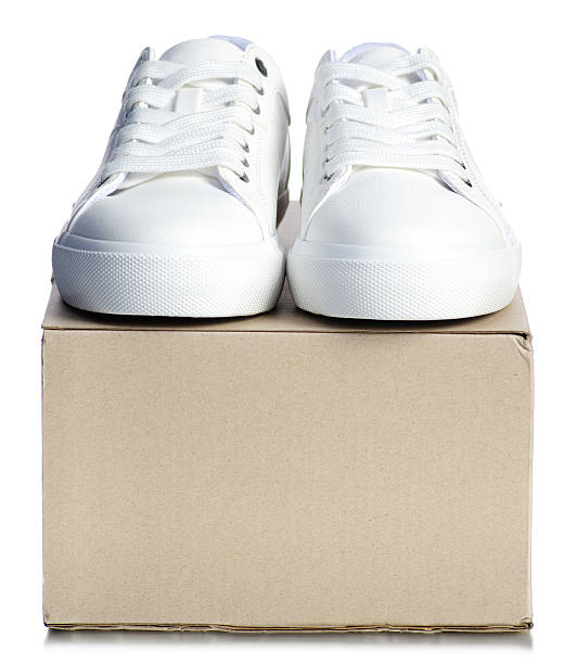 White sneakers shoelace with brown box on white background isolation