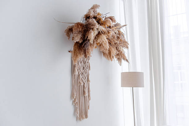 istock Pampas grass and macrame wall hanging creating cozy bohemian interior design 2205098427
